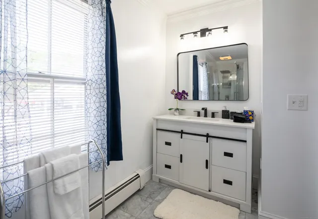 a bathroom with a sink vanity and mirror