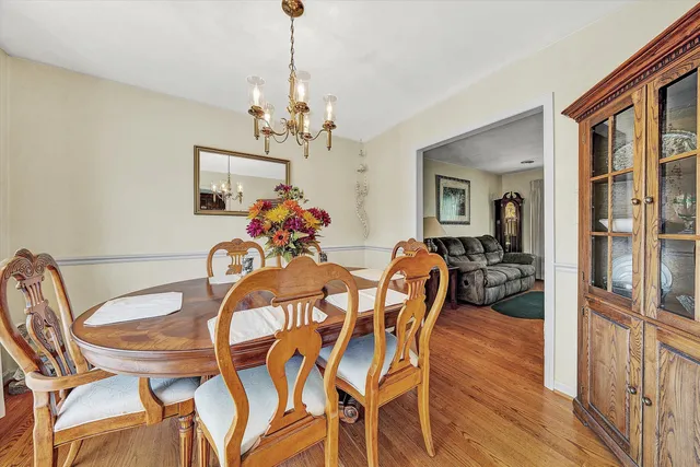 a view of a dining room with furniture wooden floor and a chandelier