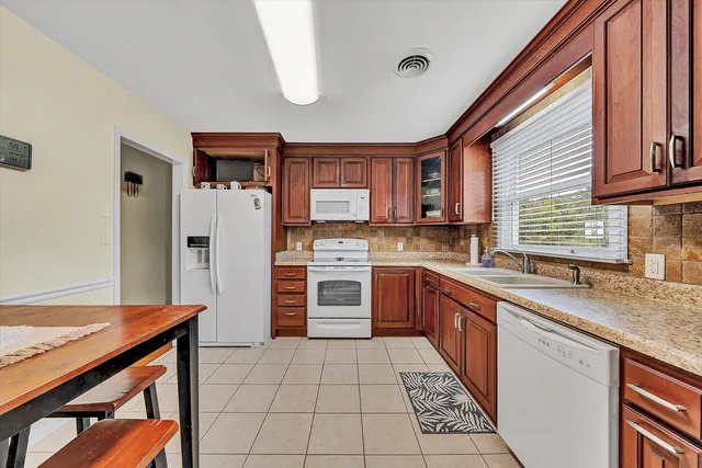 a kitchen with stainless steel appliances granite countertop a stove sink and cabinets