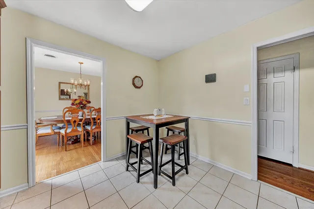 a view of a dining room with furniture and chandelier
