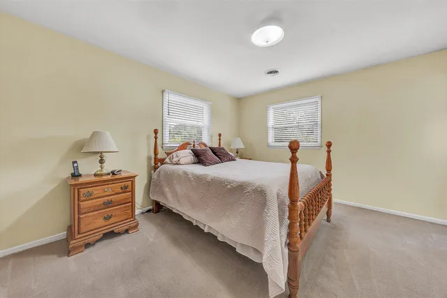 a bed room with a bed and a window