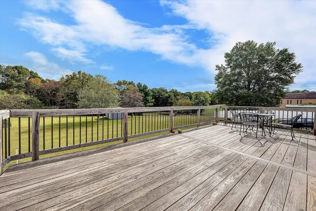 a view of deck with chairs and wooden floor