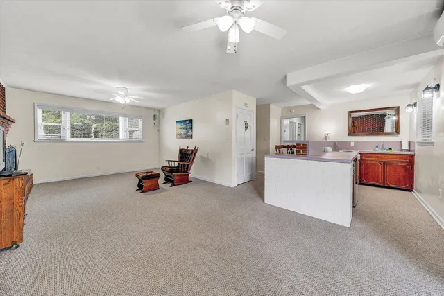 a view of a livingroom with furniture and a kitchen