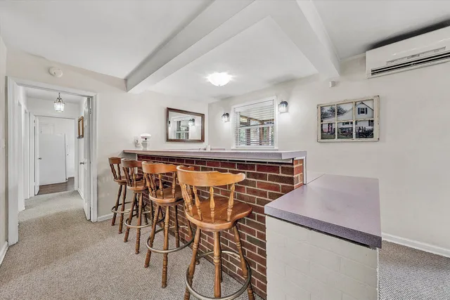 a view of a dining room with furniture and a chandelier