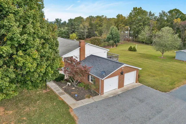 an aerial view of a house having yard with a swimming pool