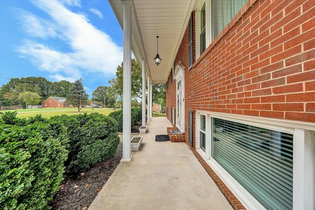 a view of a balcony with couches and wooden floor