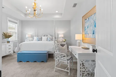 a bedroom with a bed and a chandelier