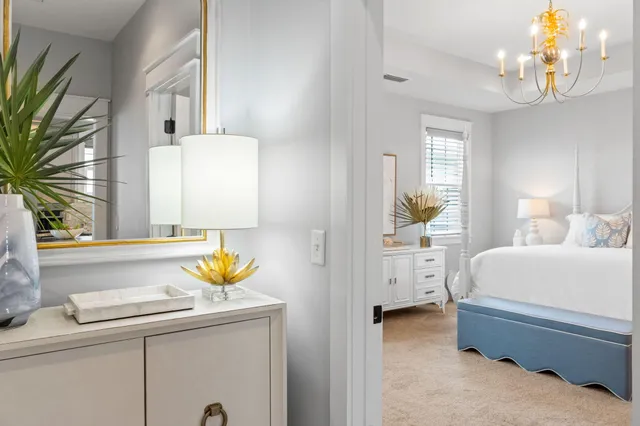 a bedroom with a bed and a chandelier