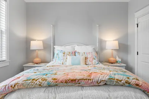 a bedroom with a bed and a lamp