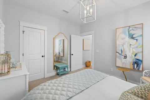 a bedroom with a bed and a chandelier