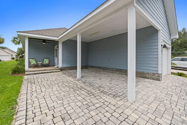 a view of house with backyard and glass windows