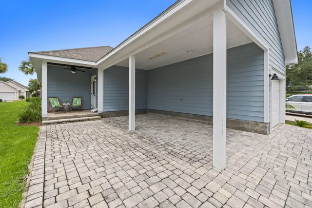 a view of house with backyard and glass windows