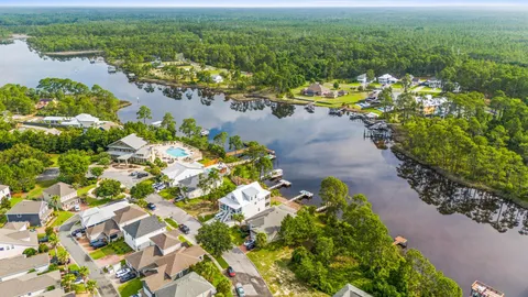 a view of a lake with lawn chairs