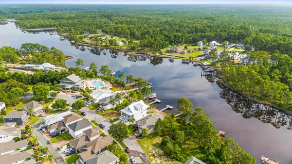 a view of a lake with lawn chairs