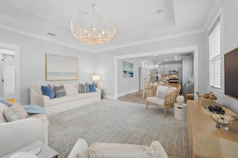 a living room with furniture and a large mirror