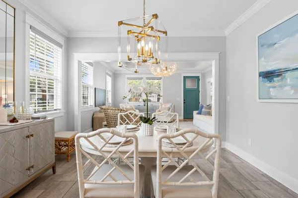 a view of a dining room with furniture wooden floor and chandelier