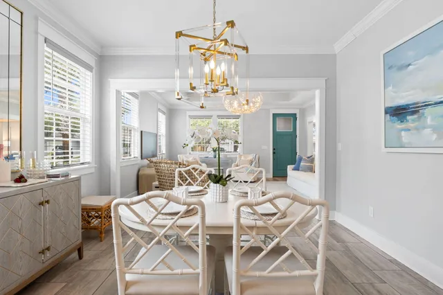 a view of a dining room with furniture wooden floor and chandelier