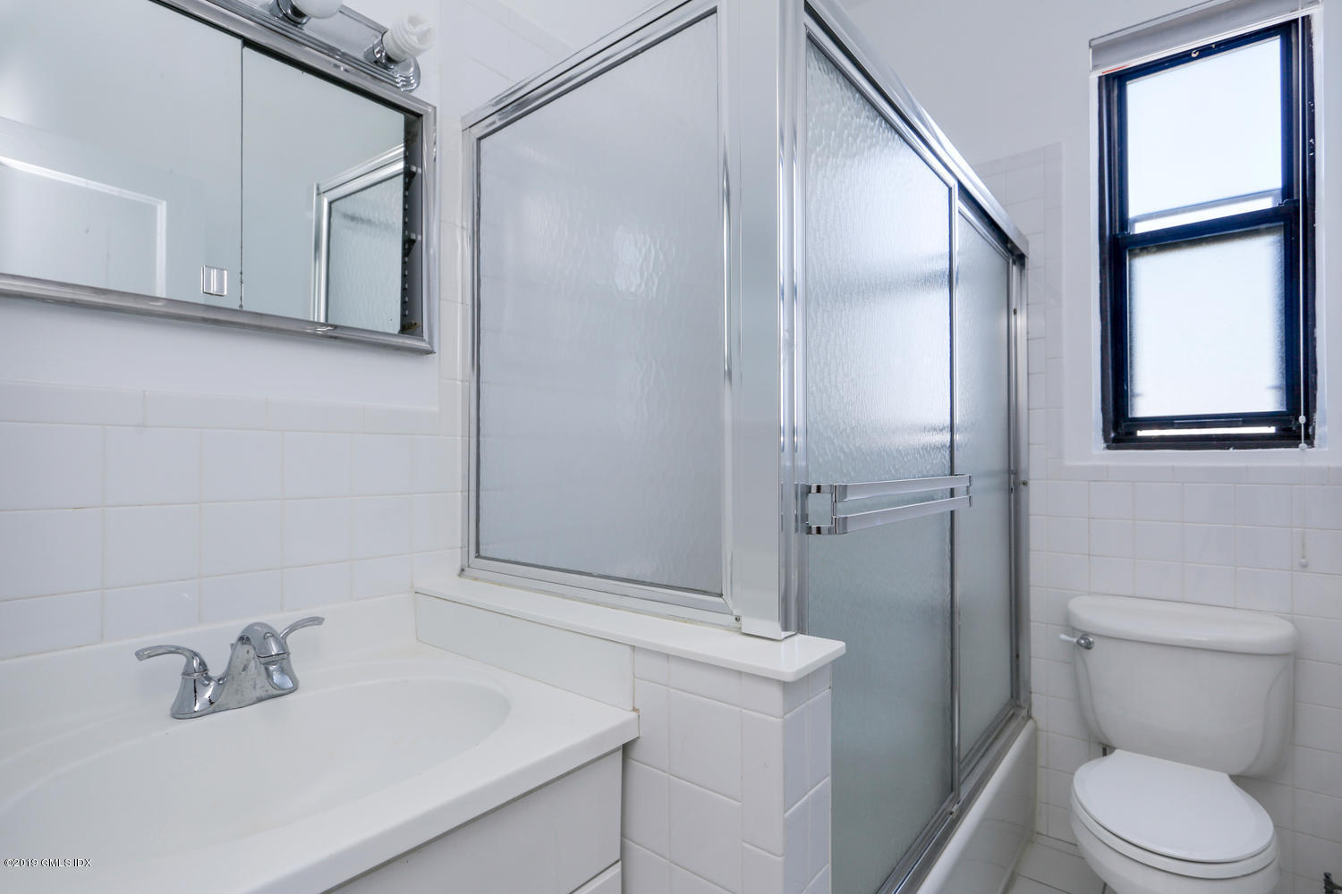 47 Lafayette Place, Unit 5D Greenwich, CT 06830 - Photo 4 of 11 a bathroom with a sink a toilet and shower