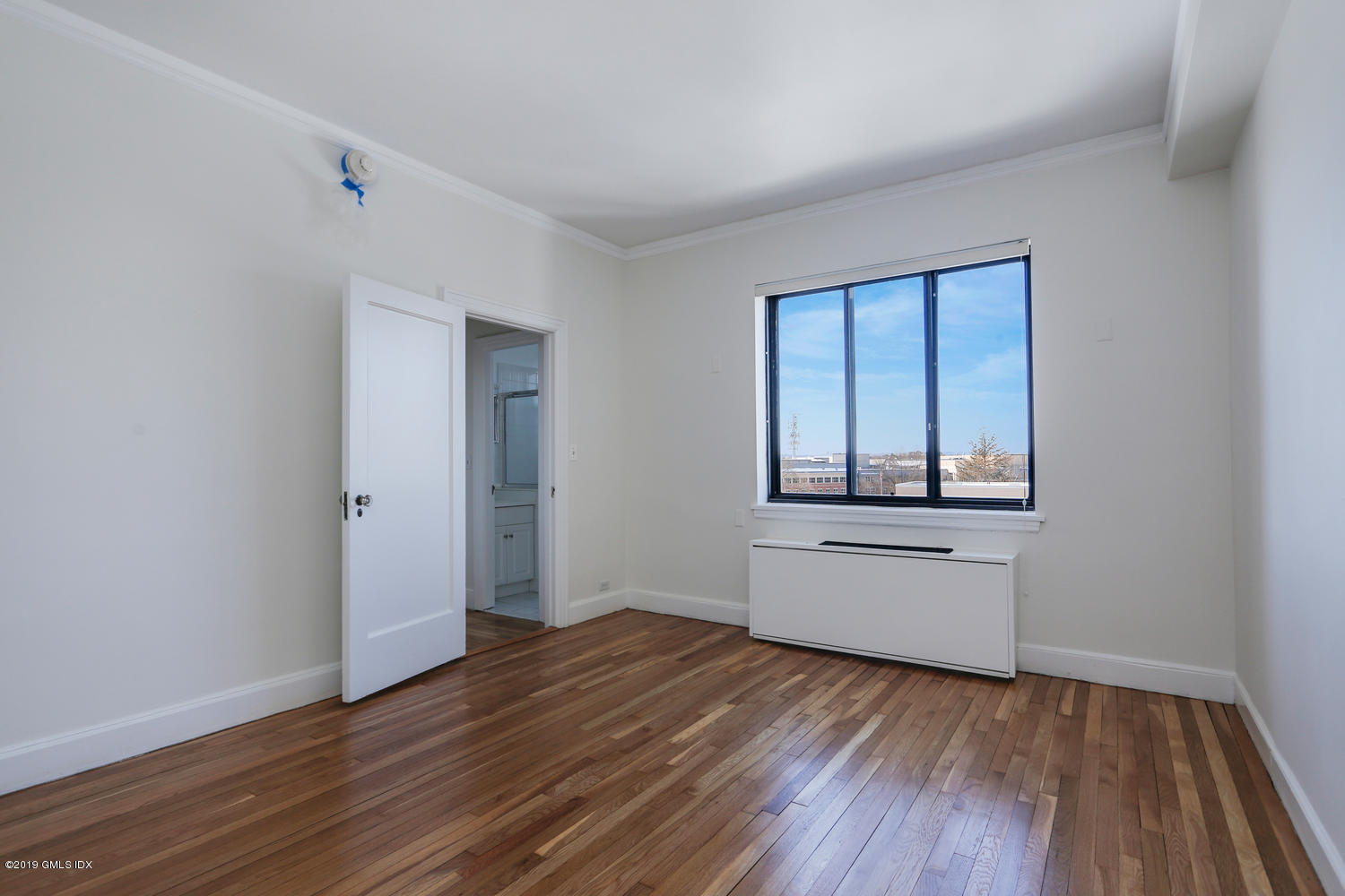 47 Lafayette Place, Unit 5D Greenwich, CT 06830 - Photo 6 of 11 wooden floor in an empty room with a window