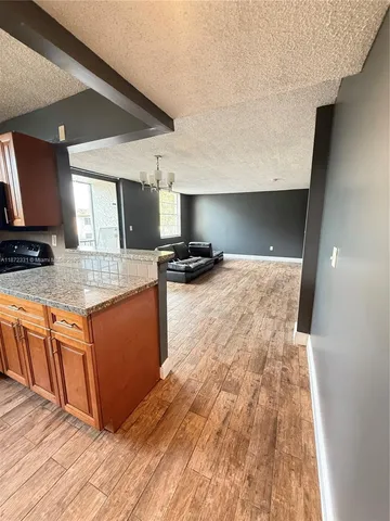a kitchen with stainless steel appliances granite countertop a sink and a stove