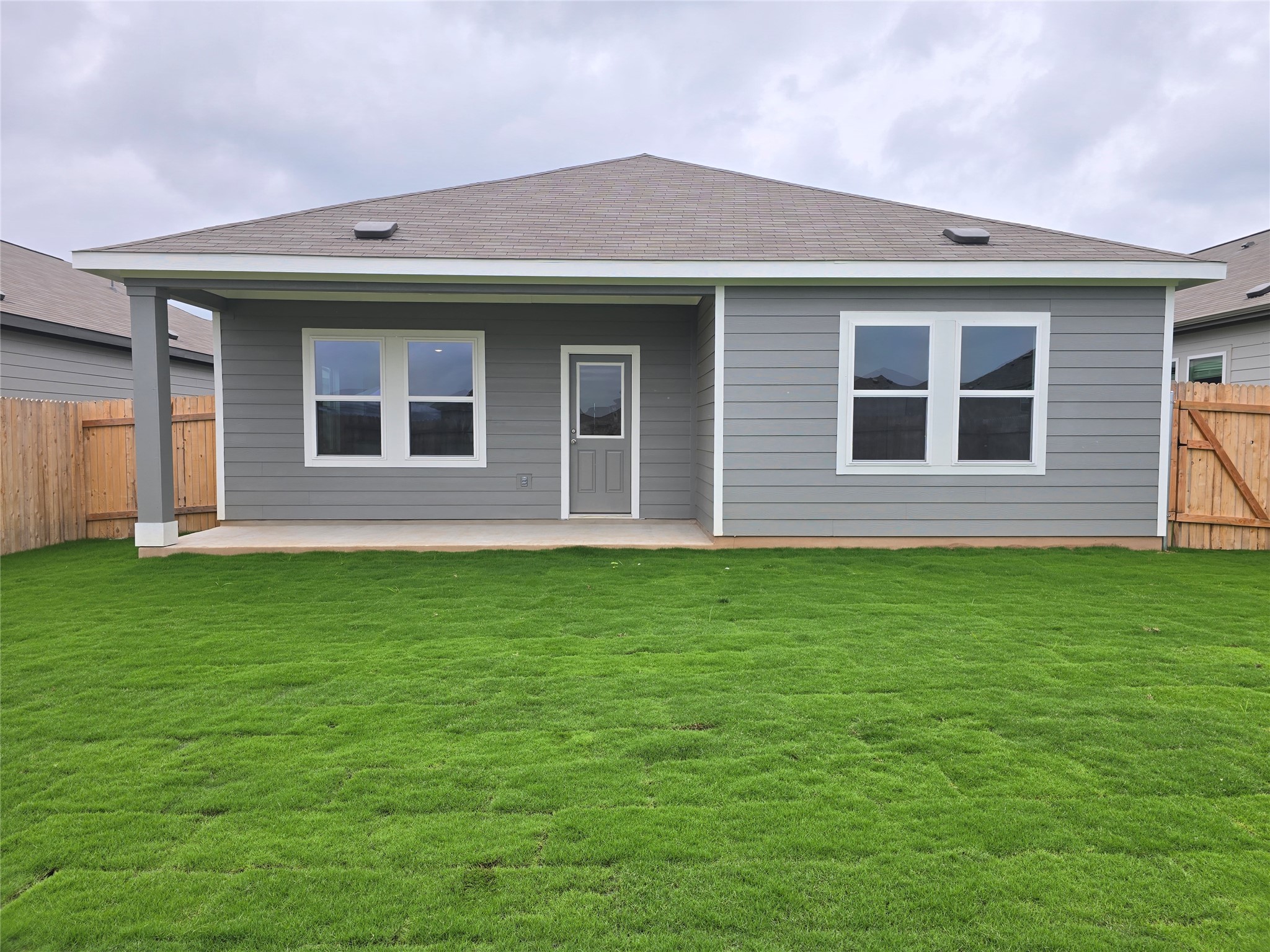 509 McFadin Way Taylor, TX 76574 - Photo 19 of 23 a front view of a house with a garden