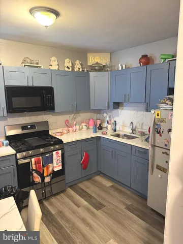 a kitchen with stainless steel appliances kitchen island granite countertop a stove refrigerator and microwave