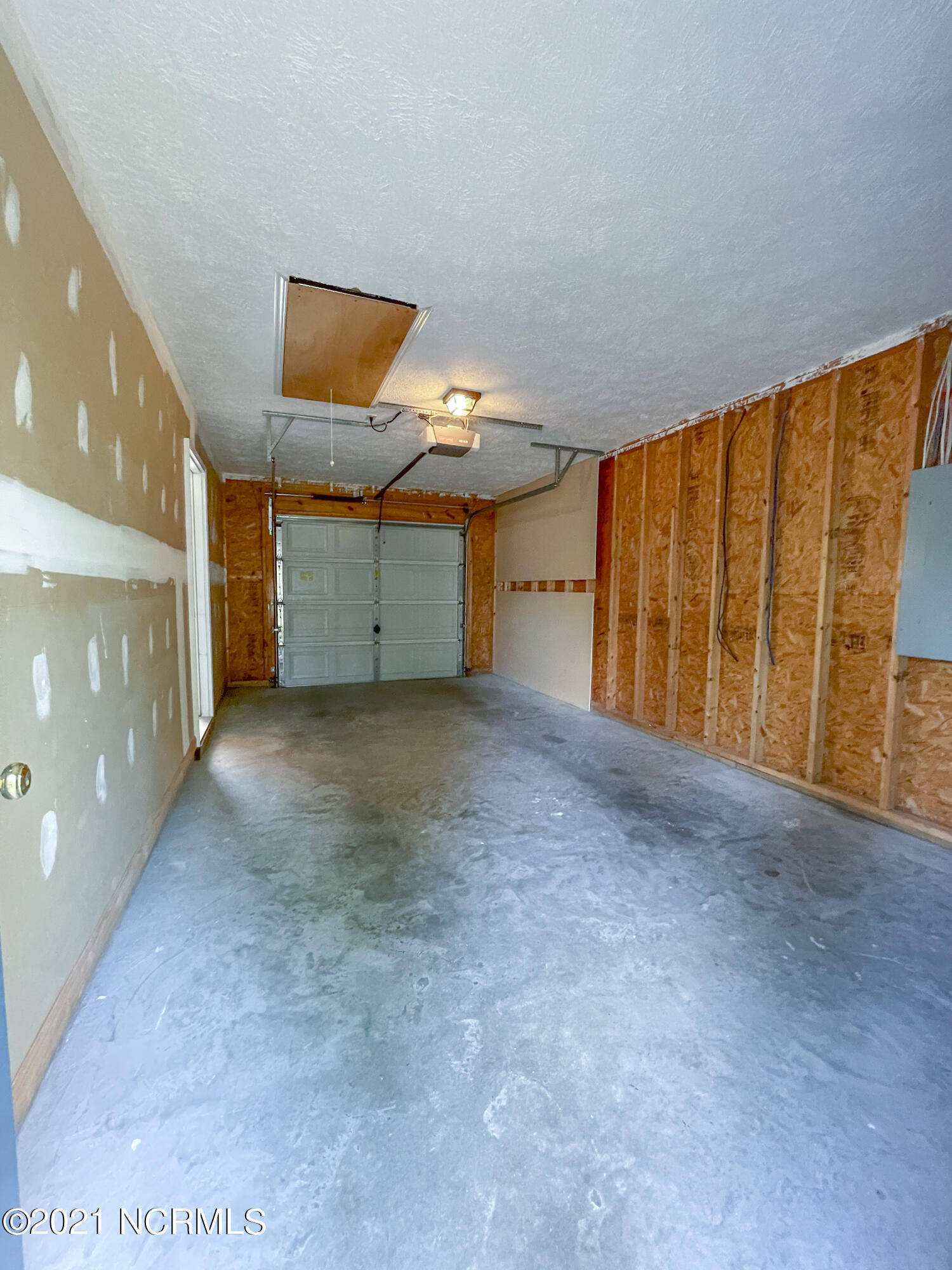 4532 Alder Ridge Road Wilmington, NC 28412 - Photo 36 of 48 Nice deep garage, atuomatic opener, attic area, irrigation controller, back door to yard behind you in this photo.
