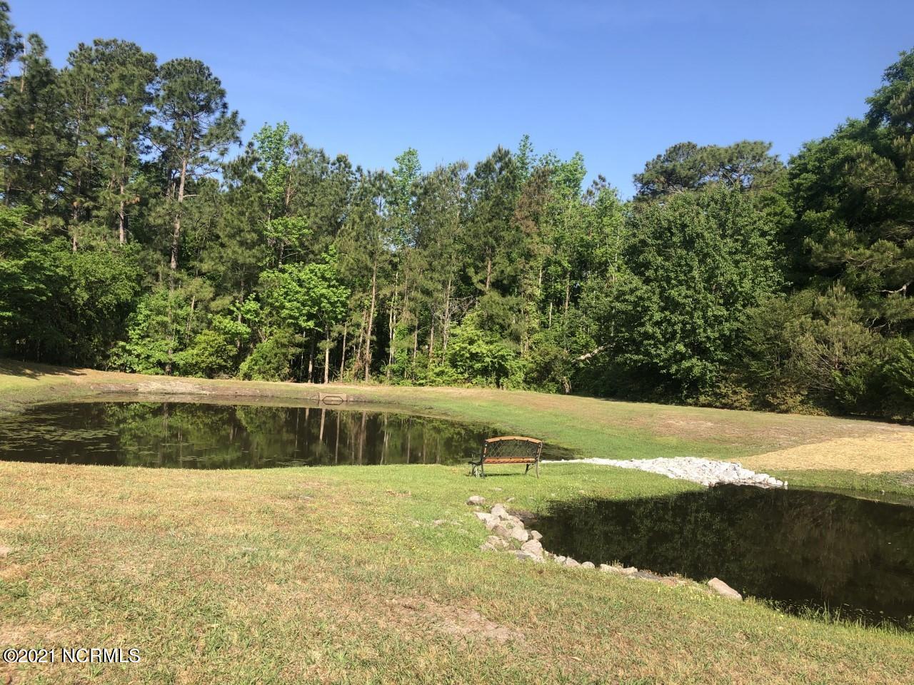 4532 Alder Ridge Road Wilmington, NC 28412 - Photo 48 of 48 Drainage ponds in the neighborhood. Note the drive in, you are going uphill most of the way.