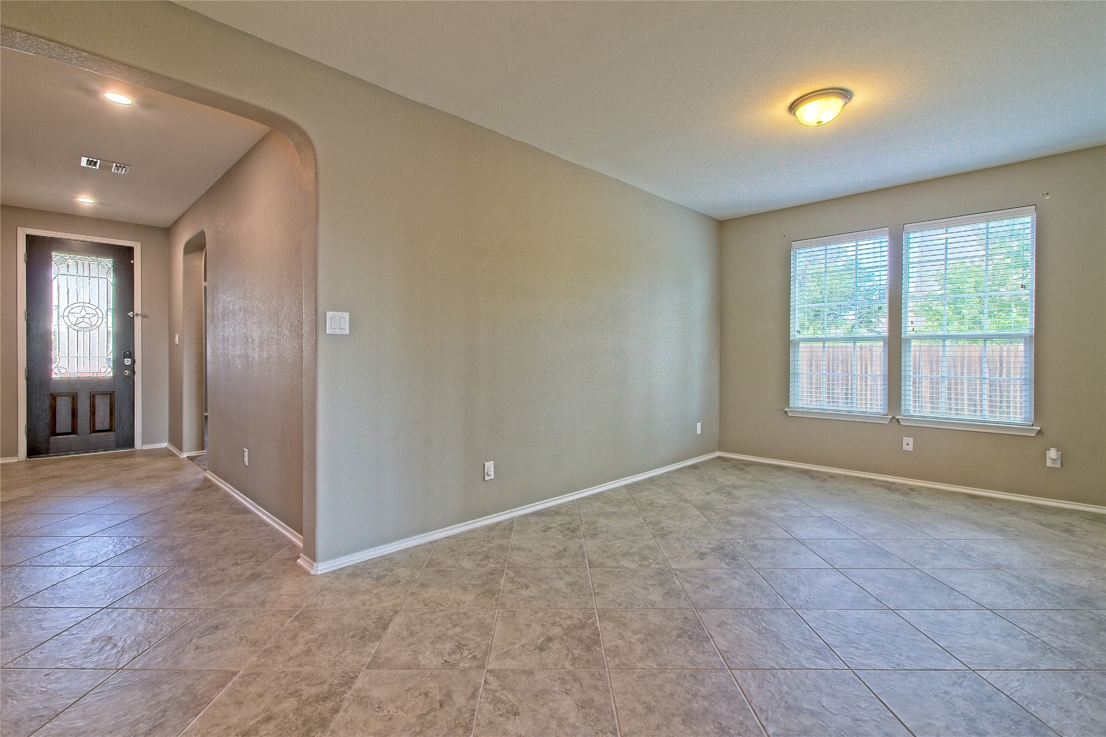 31443 Kingsway Road Georgetown, TX 78628 - Photo 5 of 40 A versatile interior space featuring durable tiled flooring and abundant natural light from dual windows.