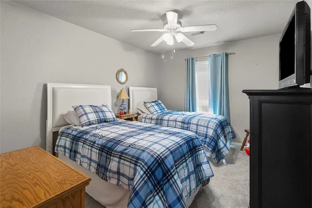 a bedroom with bed and a tv