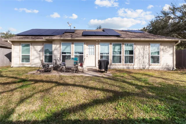 a view of a house with swimming pool and sitting area