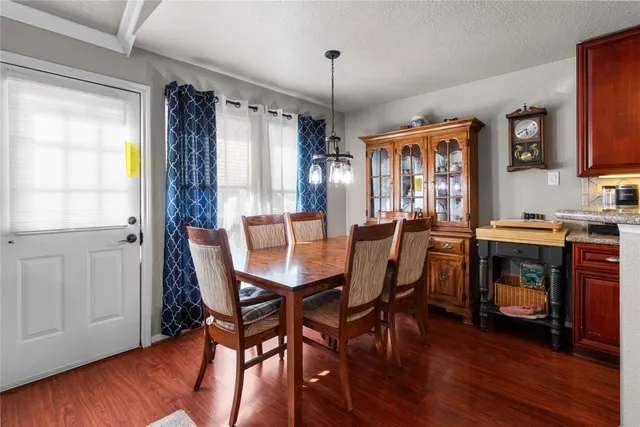 a dining room with furniture and wooden floor