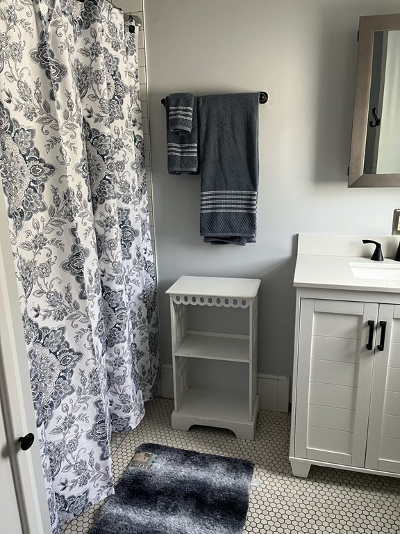 21 Blaney Street, Unit 1 Swampscott, MA 01907 - Photo 20 of 24 a bathroom with a sink and a mirror