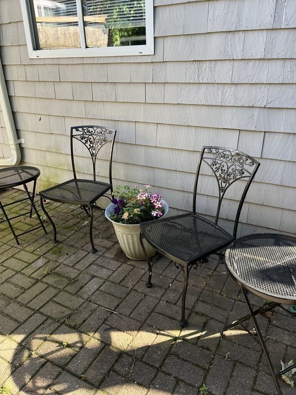 21 Blaney Street, Unit 1 Swampscott, MA 01907 - Photo 21 of 24 a view of a chairs and table in backyard