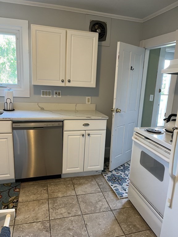21 Blaney Street, Unit 1 Swampscott, MA 01907 - Photo 10 of 24 a kitchen with a sink stove and cabinets