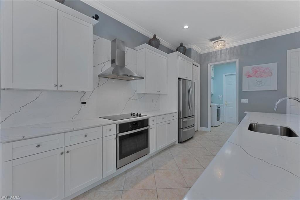 5769 Mango Circle Naples, FL 34110 - Photo 1 of 42 a kitchen with stainless steel appliances granite countertop a refrigerator and a sink