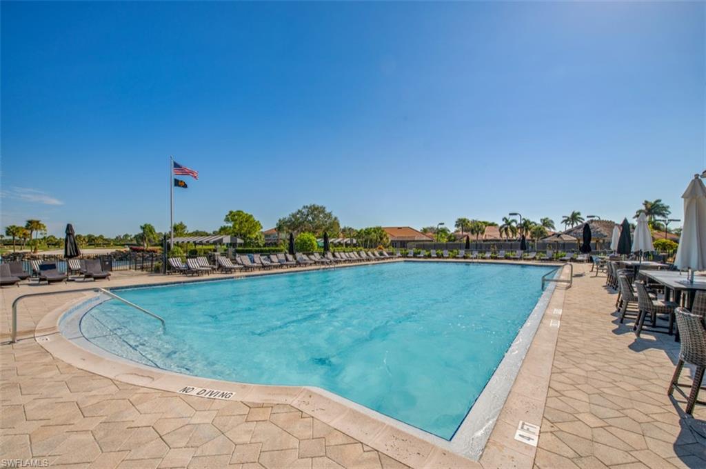 5769 Mango Circle Naples, FL 34110 - Photo 23 of 42 a view of a lake with a house
