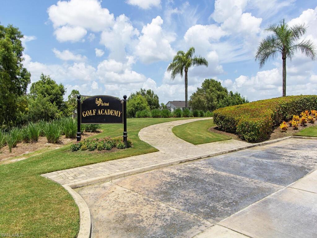 5769 Mango Circle Naples, FL 34110 - Photo 37 of 42 a view of a garden with a bench