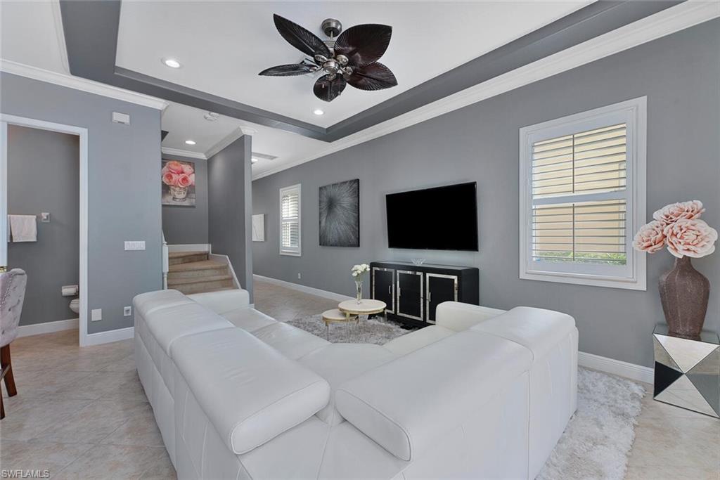 5769 Mango Circle Naples, FL 34110 - Photo 4 of 42 a bedroom with a bed and a flat screen television