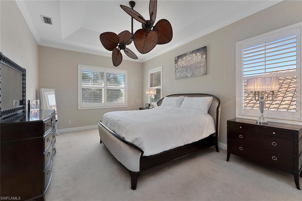 5769 Mango Circle Naples, FL 34110 - Photo 5 of 42 a bedroom with a bed dresser and window