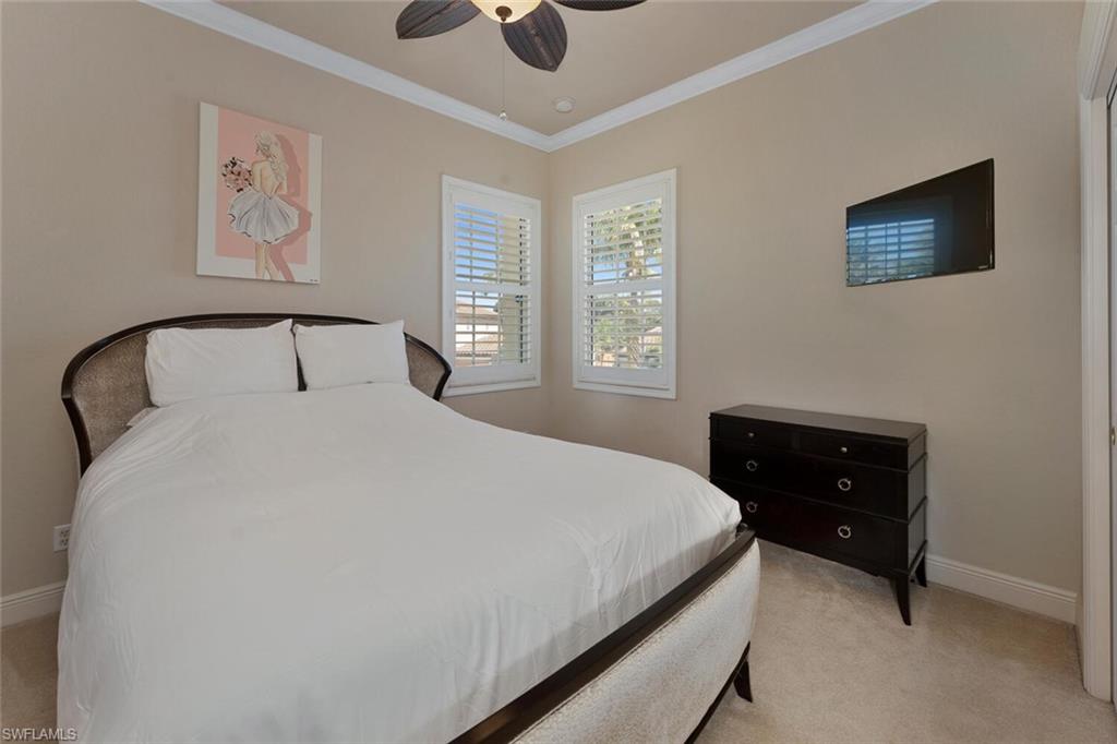 5769 Mango Circle Naples, FL 34110 - Photo 8 of 42 a bedroom with a bed and a window