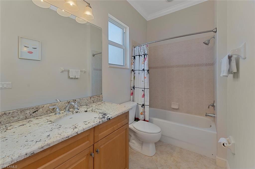5769 Mango Circle Naples, FL 34110 - Photo 9 of 42 a bathroom with a sink a toilet and shower