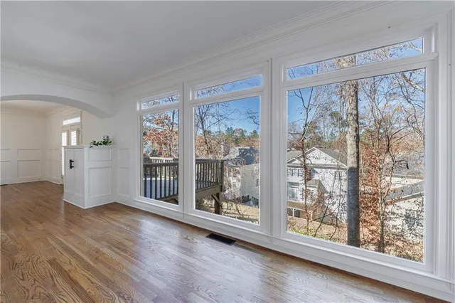 wooden floor in an empty room with a window