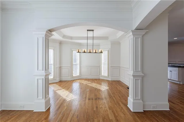 a kitchen with a refrigerator cabinets and wooden floors