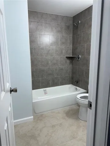 a bathroom with a bathtub and a toilet