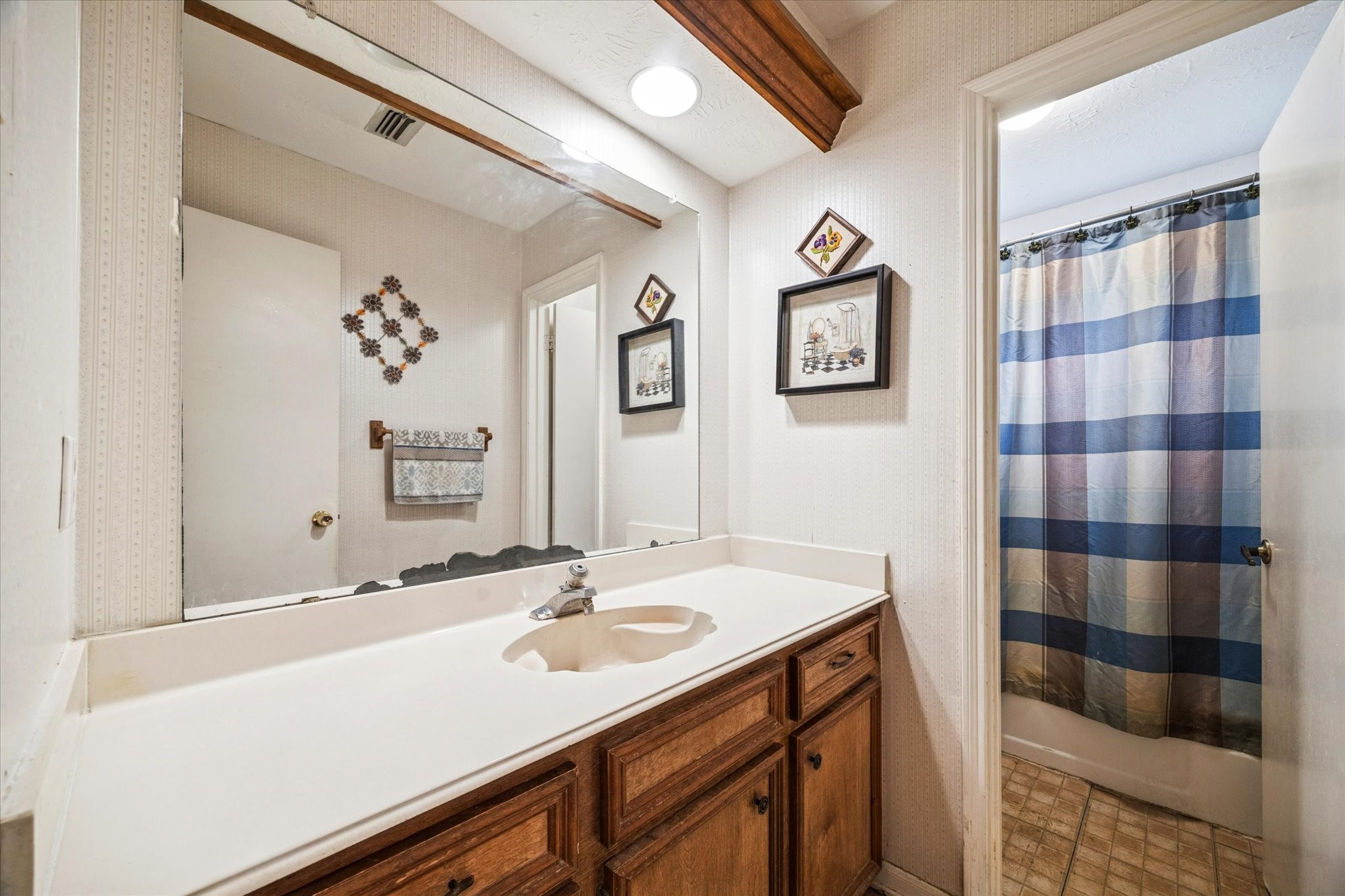 15427 Rio Plaza Drive Houston, TX 77083 - Photo 12 of 16 a bathroom with a sink and a mirror