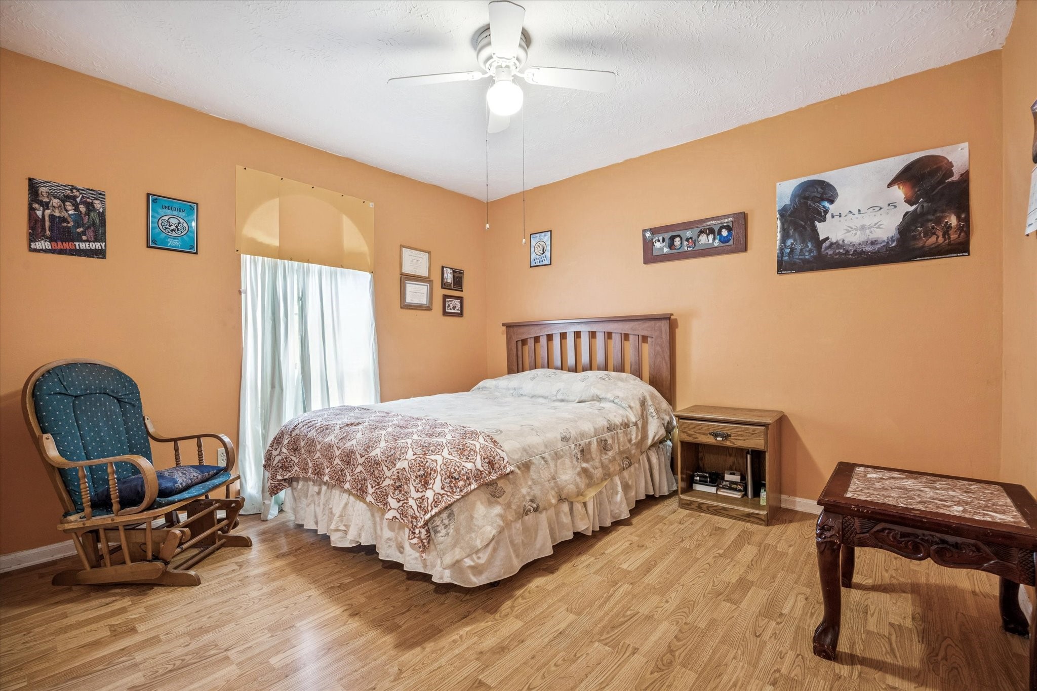 15427 Rio Plaza Drive Houston, TX 77083 - Photo 13 of 16 a bedroom with a bed a chair and a large window