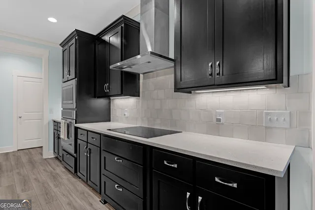 a kitchen with stainless steel appliances granite countertop a sink and a stove