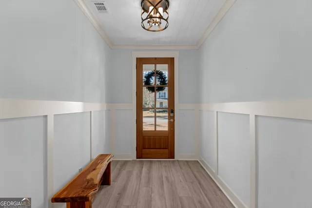 a view of an entryway with wooden floor