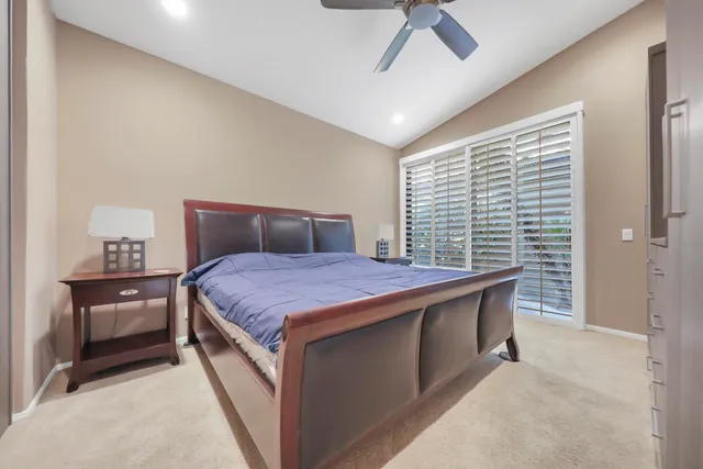 a large bedroom with a bed and a chandelier